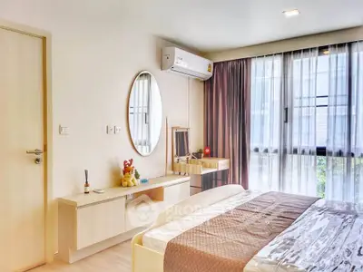 Modern bedroom with stylish decor and large window for natural light