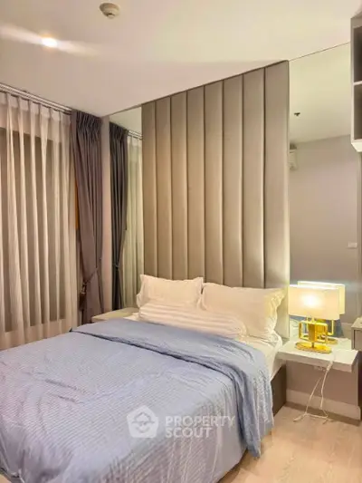 Modern bedroom with stylish decor and cozy ambiance, featuring elegant lighting and plush bedding.
