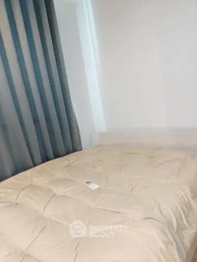 Cozy bedroom with plush bedding and modern curtains, perfect for relaxation.
