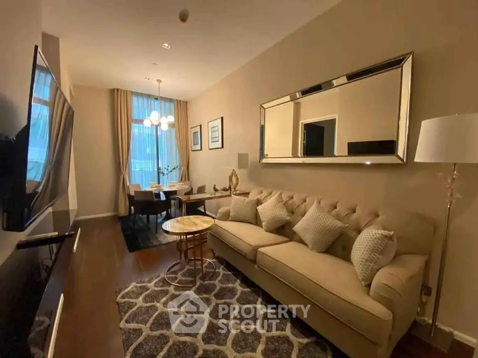 Elegant living room with plush sofa, stylish decor, and dining area in modern apartment.