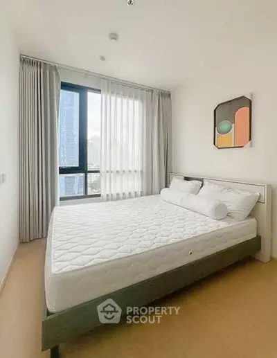 Modern bedroom with large window and stylish decor in urban apartment