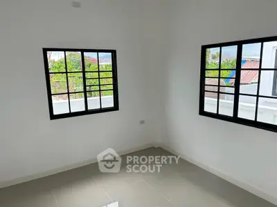 Bright empty room with large windows and tiled floor, perfect for customization.