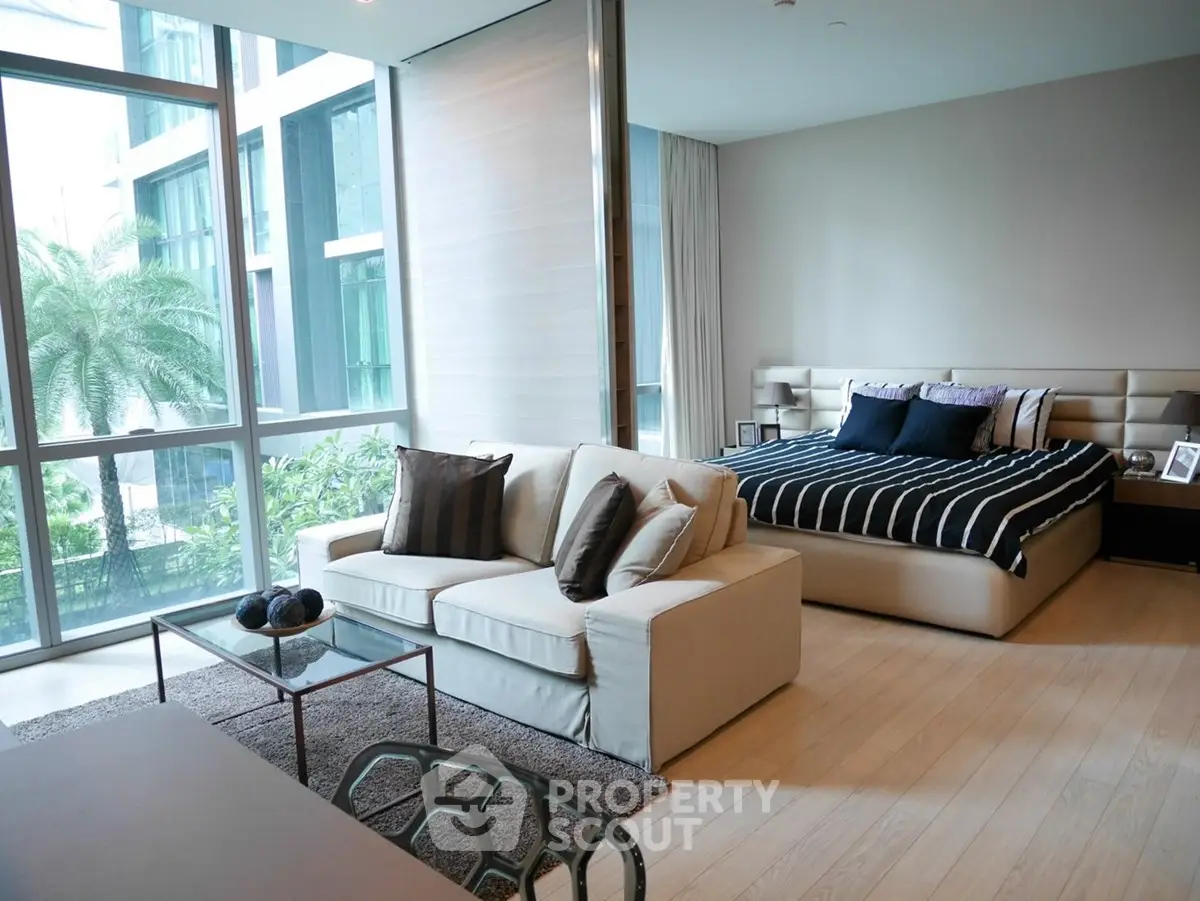 Luxurious modern bedroom with large windows and stylish decor in a high-end apartment.