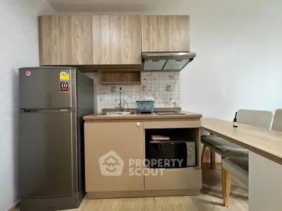 Modern kitchen with sleek appliances and cozy dining area, perfect for urban living.
