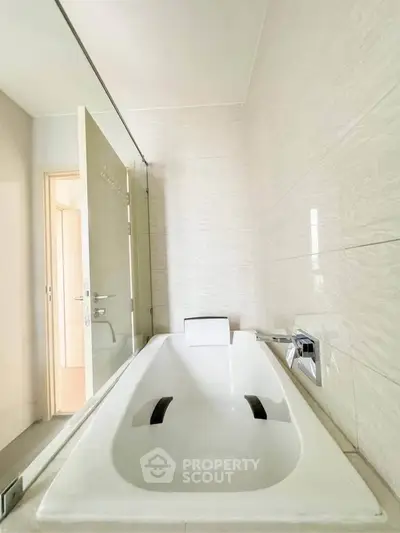 Modern bathroom with sleek bathtub and elegant tile design