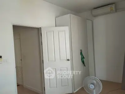 Cozy bedroom with air conditioning and wardrobe, perfect for comfortable living.