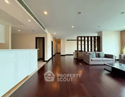 Spacious modern living room with hardwood floors and elegant furniture