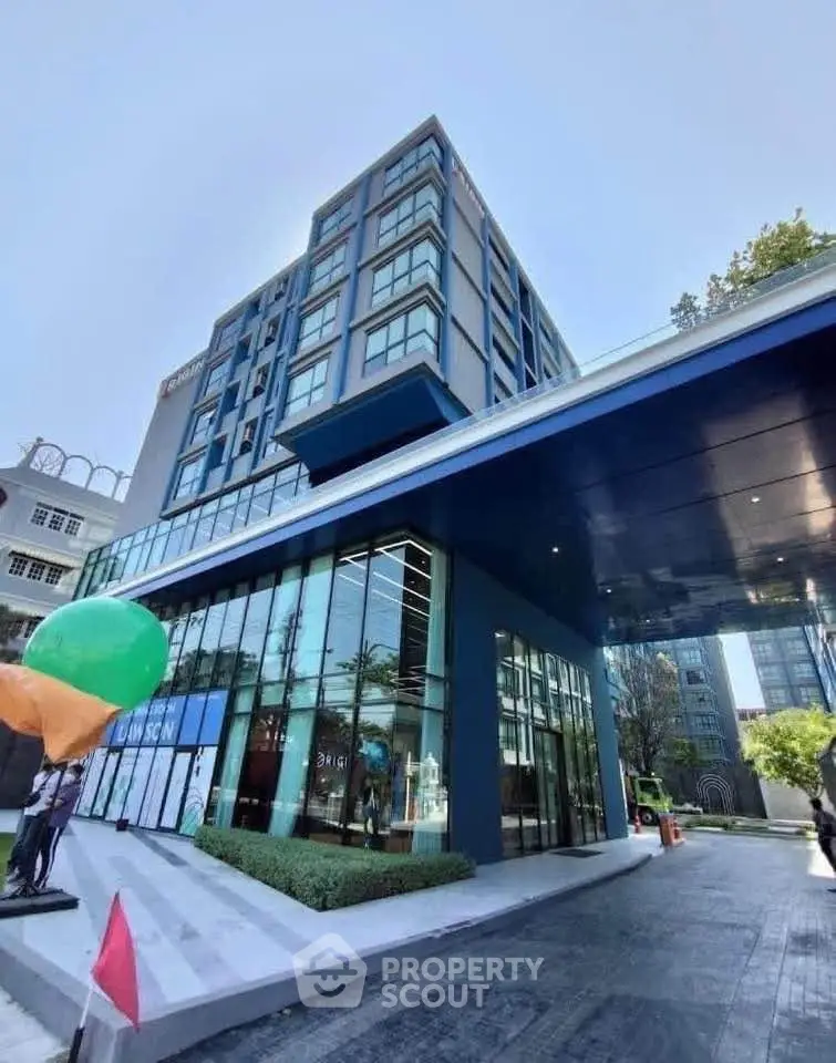 Modern high-rise building with sleek glass facade and contemporary design.