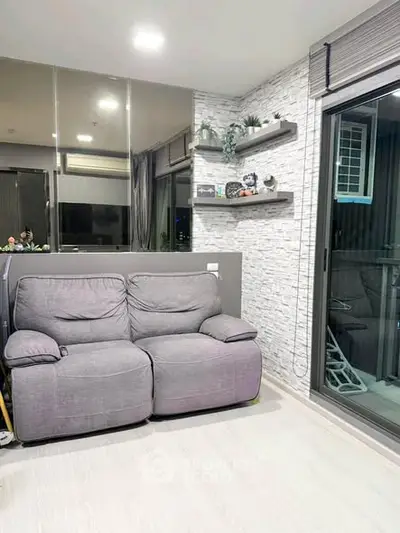 Modern living room with cozy gray sofa and stylish wall shelves