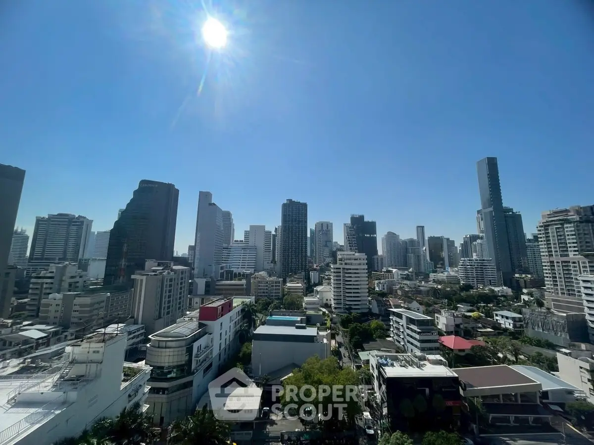 Stunning cityscape view of modern skyscrapers under a bright blue sky, perfect for urban living enthusiasts.