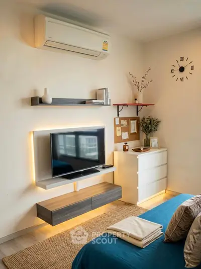 Modern bedroom with stylish TV setup and ambient lighting