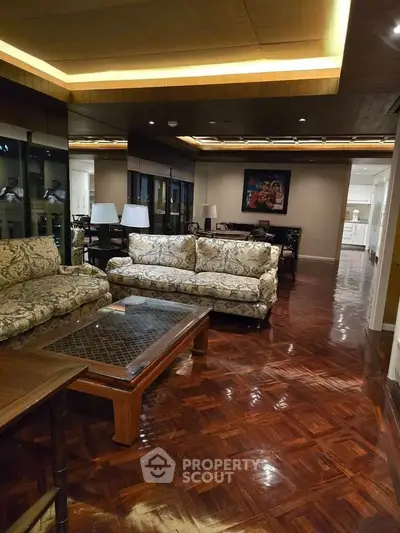 Luxurious living room with elegant furniture and polished wooden floors in a spacious open layout.