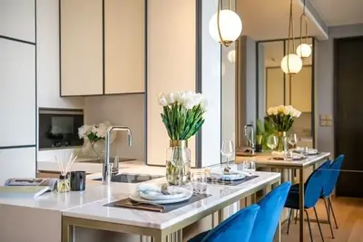 Luxurious modern kitchen with elegant dining setup and stylish lighting