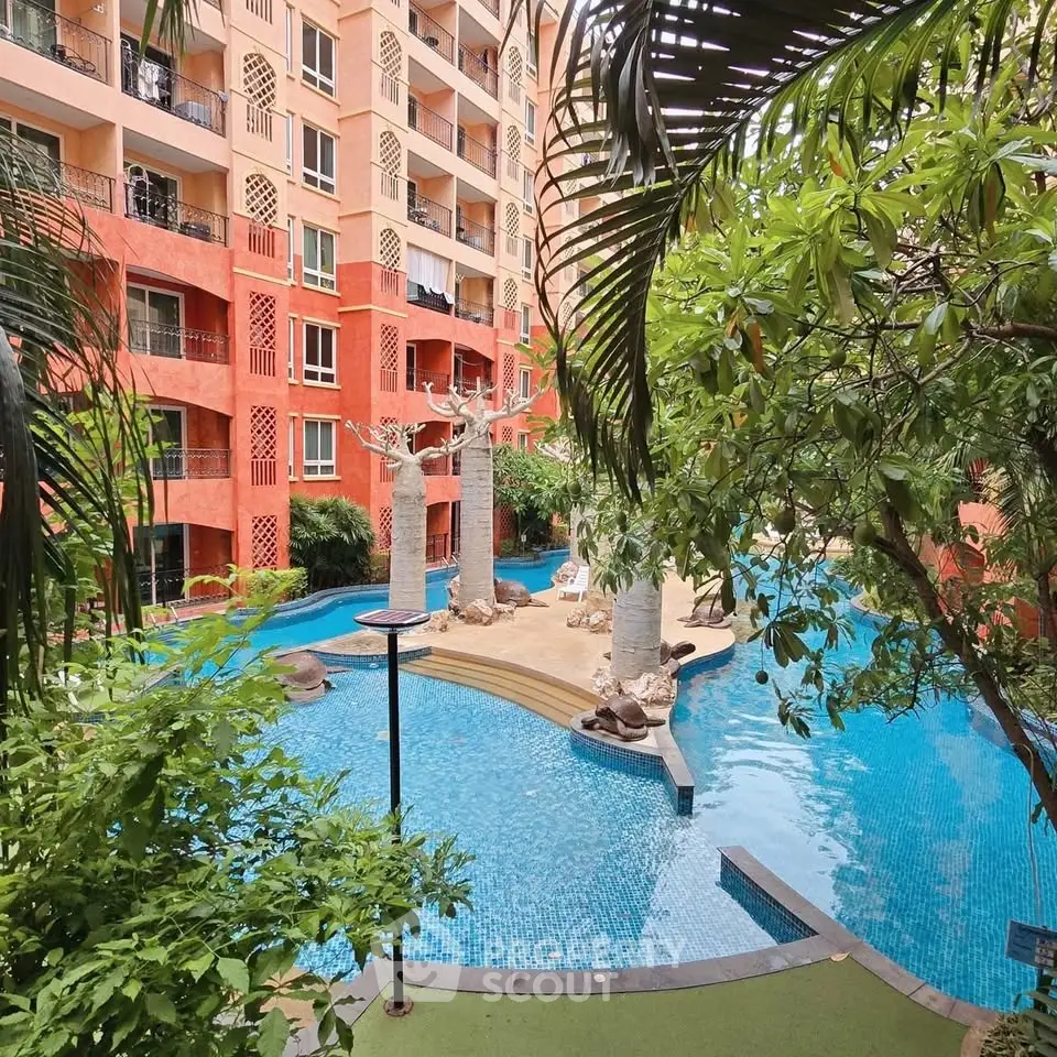Luxurious apartment complex with stunning pool and lush greenery