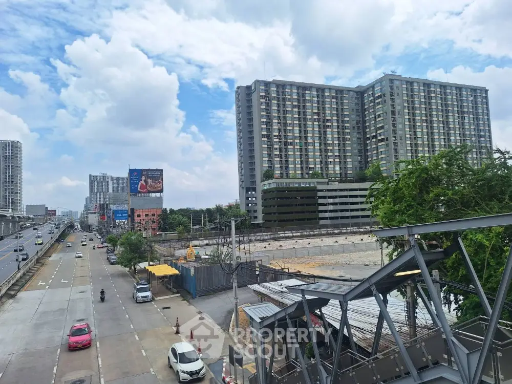 Modern urban landscape with high-rise buildings and clear blue sky.