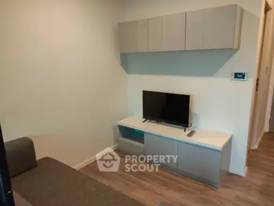 Modern living room with sleek TV stand and wall-mounted cabinets, perfect for compact spaces.