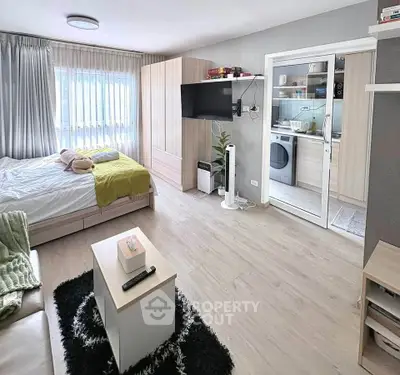 Modern studio apartment with open layout, featuring a cozy bedroom and living area, and a compact kitchen.