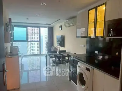 Modern kitchen with open layout and city view, featuring sleek appliances and dining area.