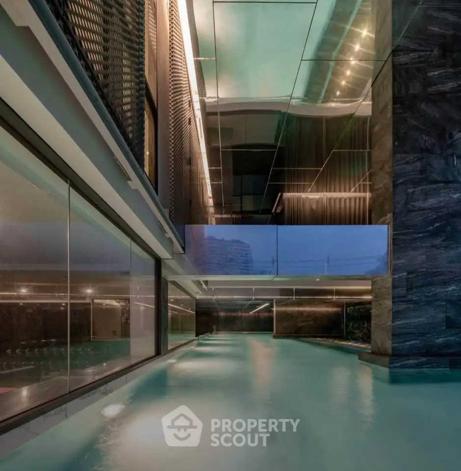 Luxurious indoor pool with modern architectural design and ambient lighting