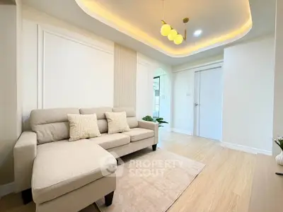 Elegant living room with modern lighting and cozy beige sofa in a stylish apartment.