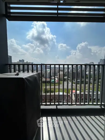 Stunning balcony view with cityscape and clear skies, perfect for urban living.