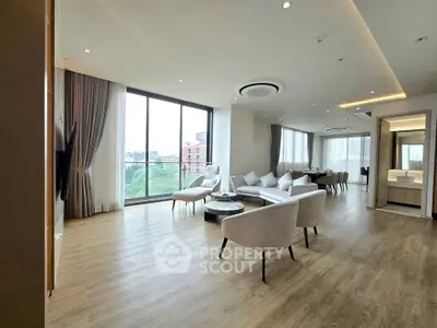 Spacious modern living room with large windows and elegant furnishings