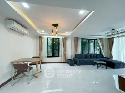 Spacious modern living room with elegant lighting and large windows