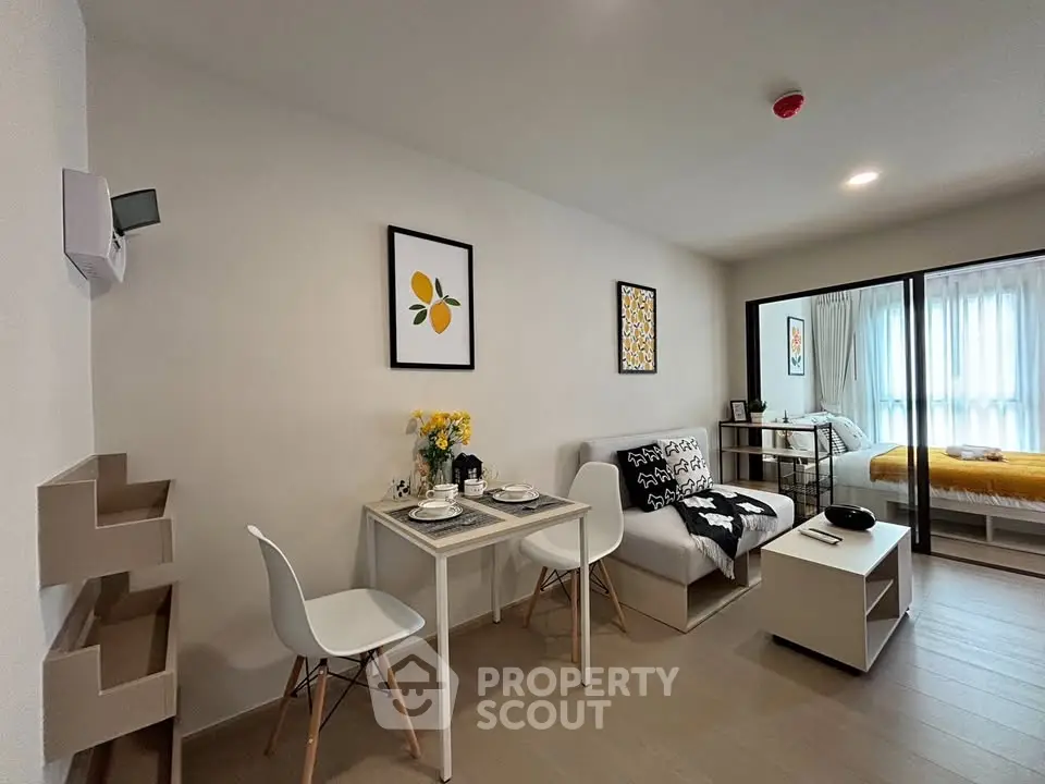 Modern living room with dining area and cozy bedroom in open layout apartment