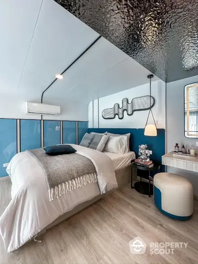 Modern bedroom with stylish decor and cozy bedding in a contemporary apartment.