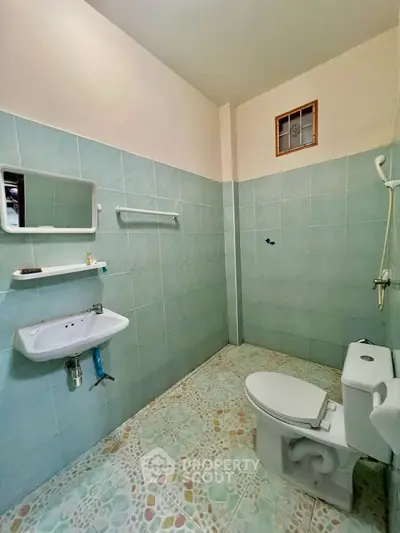 Spacious bathroom with modern fixtures and tiled walls, ideal for comfort and convenience.