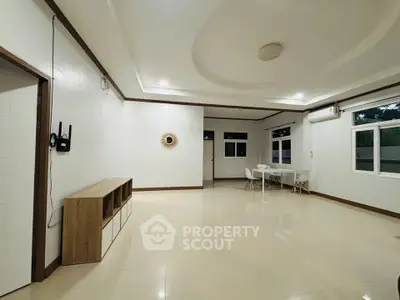 Spacious modern living room with minimalist decor and large windows