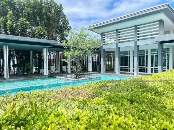 Modern property with pool and lush greenery, perfect for luxury living.