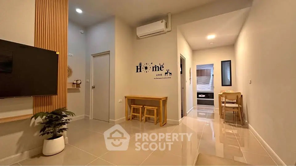 Modern living room with sleek design and cozy dining area, featuring air conditioning and stylish decor.