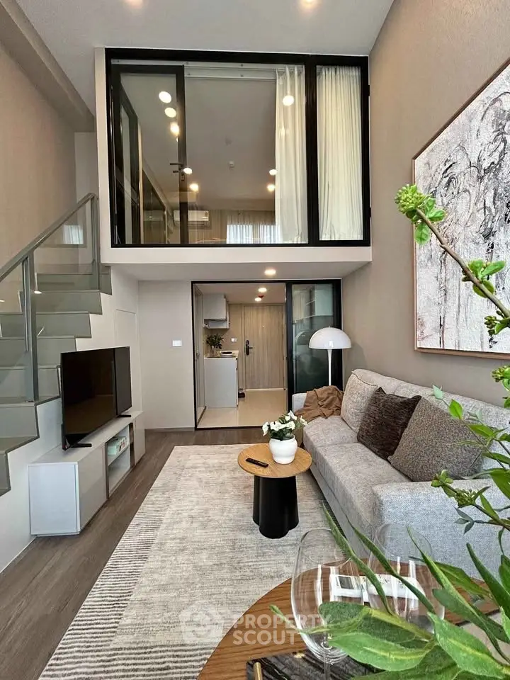 Modern loft-style living room with mezzanine, stylish decor, and open layout.