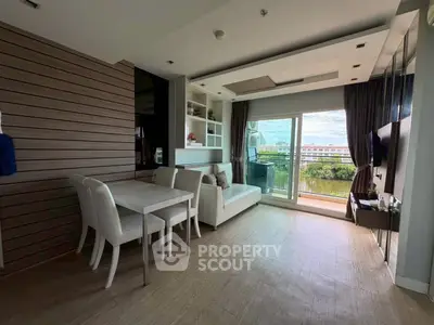 Modern living room with stylish decor and balcony view, perfect for urban living.