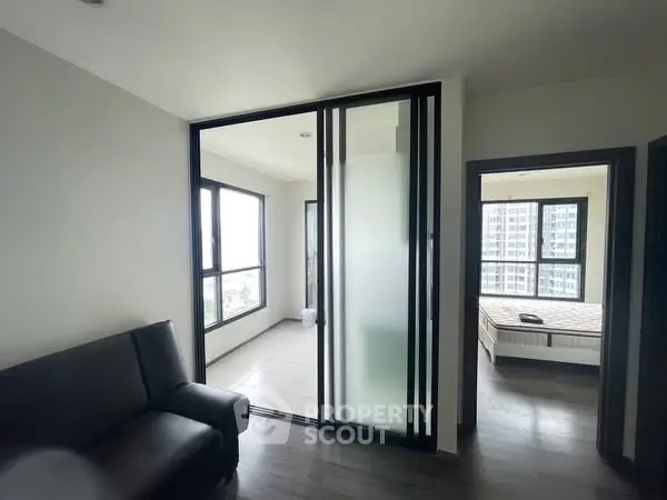 Modern apartment interior with sliding glass doors and natural light