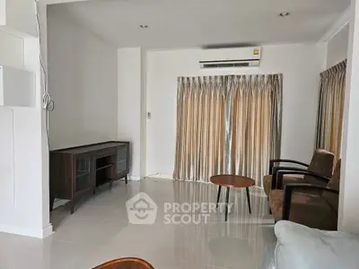 Spacious living room with modern furniture and air conditioning