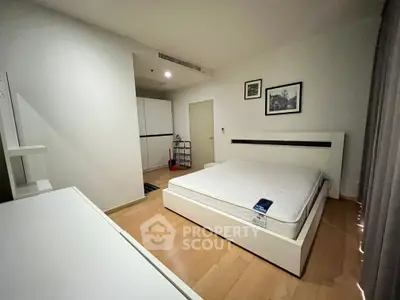 Spacious modern bedroom with minimalist design and wooden flooring