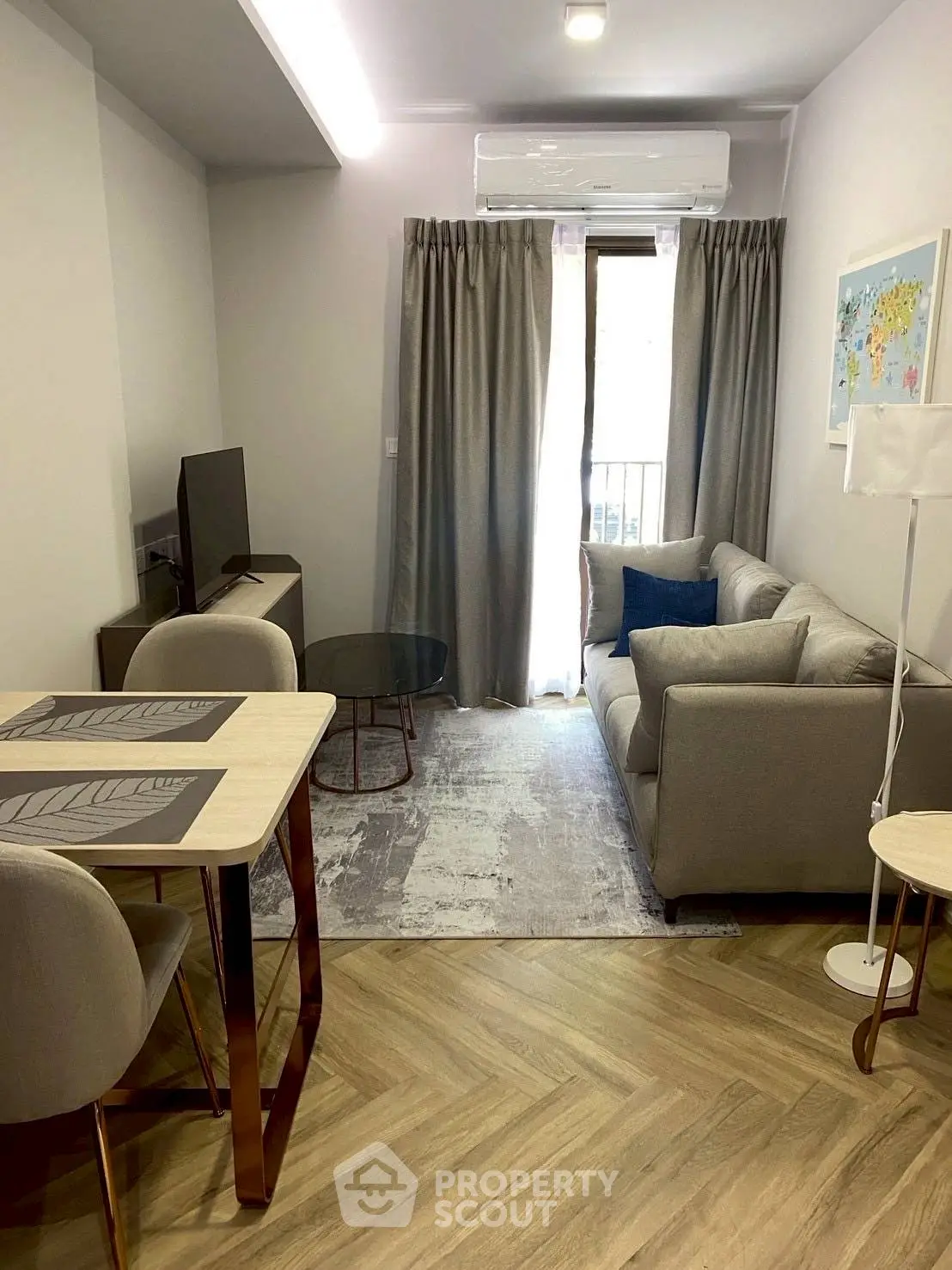 Modern living room with cozy sofa and stylish decor in a compact apartment.