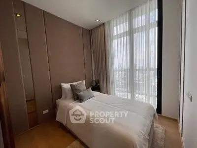 Cozy modern bedroom with large window and elegant decor