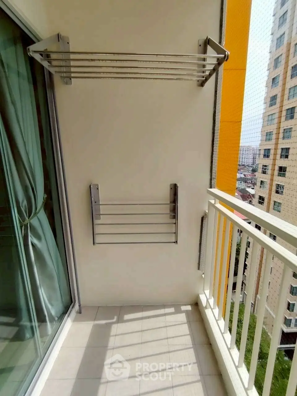 Charming balcony with city view, perfect for relaxation and enjoying the urban skyline.