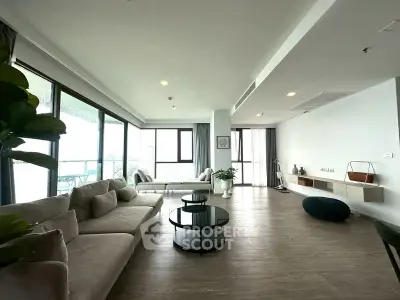 Spacious modern living room with large windows and elegant decor