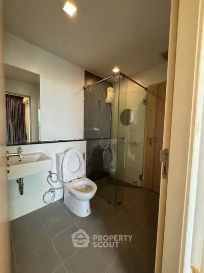 Modern bathroom with glass shower enclosure and sleek fixtures