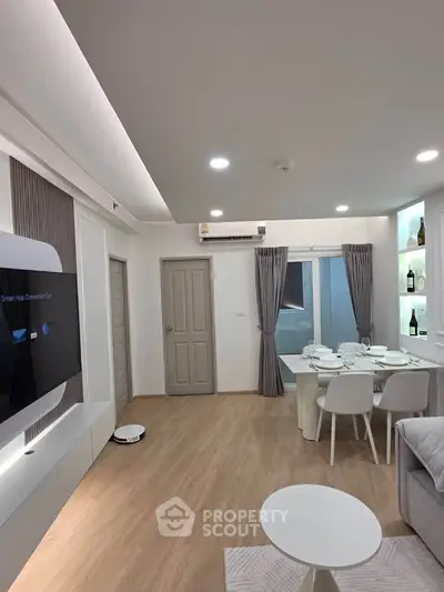 Modern living room with sleek decor, dining area, and smart TV setup, perfect for contemporary urban living.