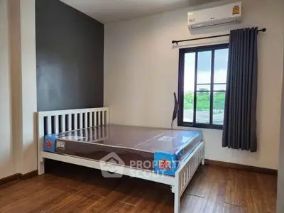 Modern bedroom with wooden flooring and large window offering scenic views.