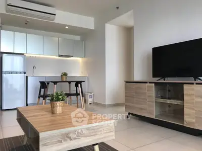 Modern open-layout living room with sleek kitchen and stylish furniture in a contemporary apartment.