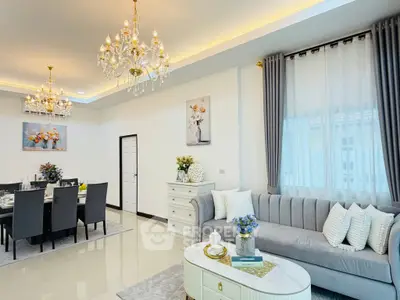 Luxurious living and dining area with elegant chandeliers and modern decor
