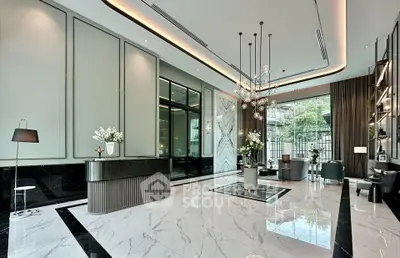 Luxurious modern lobby with marble flooring and elegant lighting fixtures.