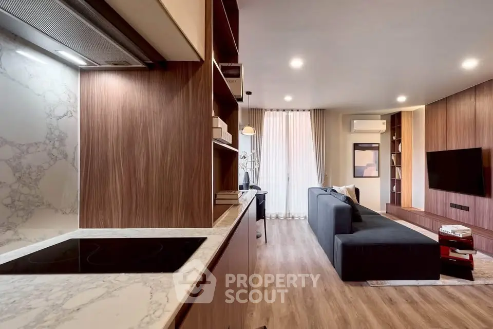 Modern open-layout living room with sleek kitchen and stylish decor