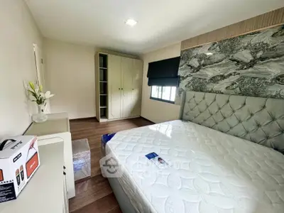Modern bedroom with stylish headboard and ample storage space